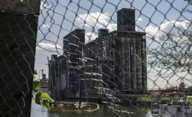 Debris of the Victory Chimes and the Pilot floats next to abandoned Red Hook Grain Terminal in the Henry Street Basin, Wednesday, Aug. 26, 2026, in the Brooklyn borough of New York. (AP Photo/Yuki Iwamura)
