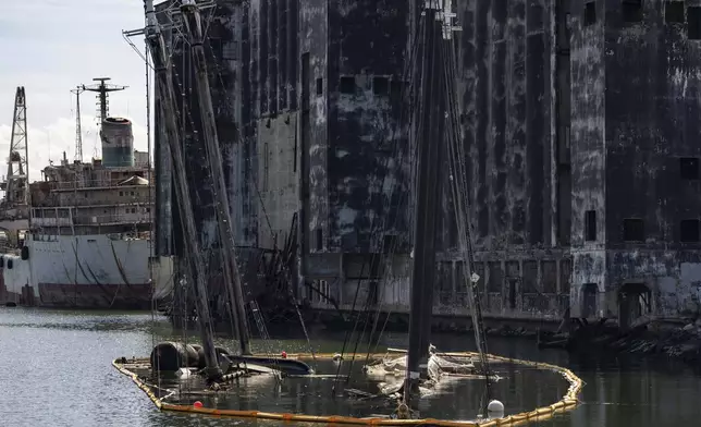 Debris of the Victory Chimes and the Pilot floats in the Henry Street Basin, Wednesday, Aug. 26, 2026, in the Brooklyn borough of New York. (AP Photo/Yuki Iwamura)