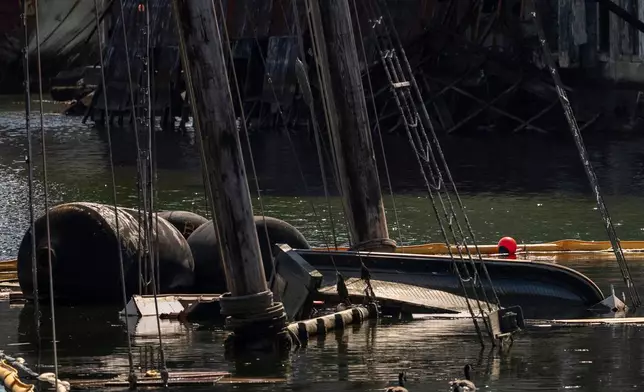Debris of the Victory Chimes and the Pilot floats in the Henry Street Basin, Wednesday, Aug. 26, 2026, in the Brooklyn borough of New York. (AP Photo/Yuki Iwamura)