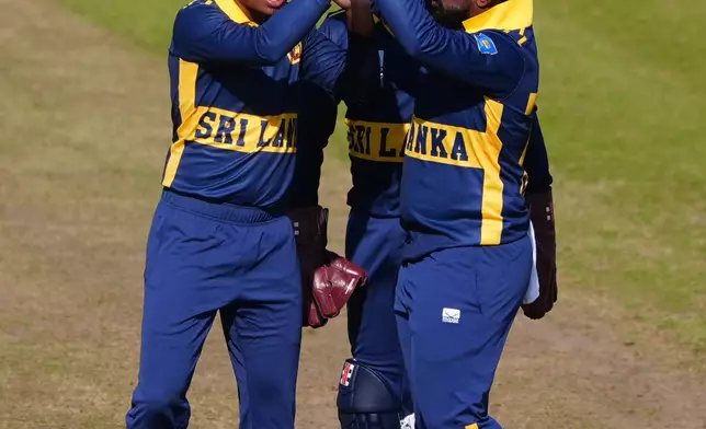 Sri Lanka's Dunith Wellalage, left, celebrates the wicket of England's Ben Duckett during the 1st one day international cricket match between England and Sri Lanka in Chester-le-Street, England, Tuesday Sept. 22, 2026. (Owen Humphreys/PA via AP)