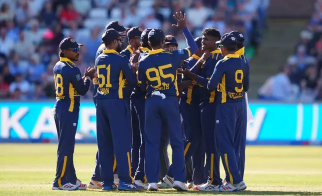 Sri Lanka players celebrate the wicket of England's Jos Butler during the 1st one day international cricket match between England and Sri Lanka in Chester-le-Street, England, Tuesday Sept. 22, 2026. (Owen Humphreys/PA via AP)