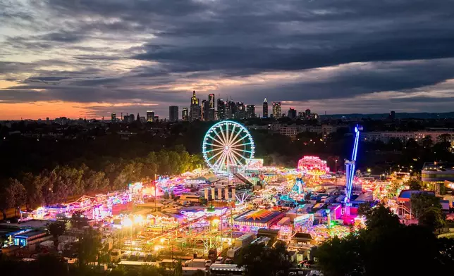 A ferris wheel turns on the first day of the Dippemess autumn fun fair in Frankfurt, Germany, Friday, Sept. 11, 2026. (AP Photo/Michael Probst)
