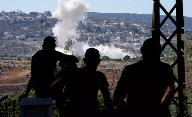 People from Mansouri watch smoke billow from an Israeli-controlled detonation destroying their village, as seen from Hanniyeh village, southern Lebanon, Friday, Sept. 11, 2026. (AP Photo/Hussein Malla)