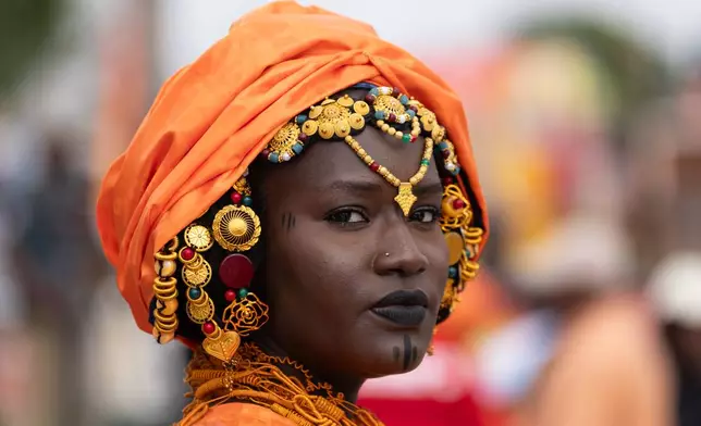 A woman takes part in a procession during an Olympic torch lighting ceremony, ahead of the Dakar 2026 Youth Olympic Games, in Dakar, Senegal, Saturday, Sept. 12, 2026. (AP Photo/Sylvain Cherkaoui)