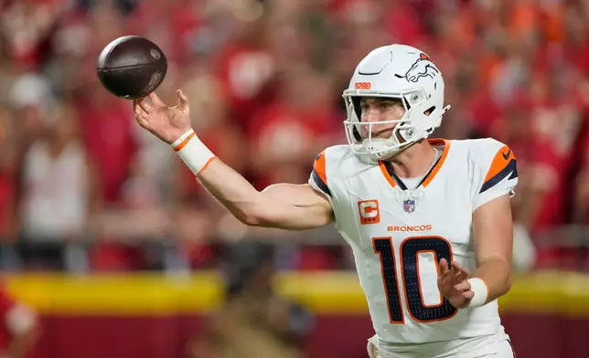 Denver Broncos quarterback Bo Nix throws a pass against the Kansas City Chiefs during the first half of an NFL football game Monday, Sept. 14, 2026, in Kansas City, Mo. (AP Photo/Charlie Riedel)