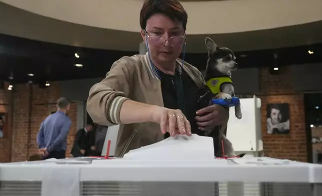 A voter casts a ballot in the parliamentary election in Moscow, Sunday, Sept. 20, 2026. (AP Photo/Pavel Bednyakov)