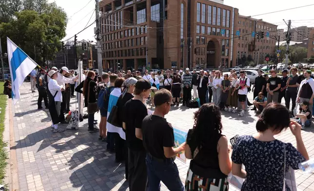 Russian citizens line up outside the Russian Embassy to join an anti-war demonstration to protest the ruling United Russia party and Moscow's ongoing invasion of Ukraine in Yerevan, Armenia, Sunday, Sept. 20, 2026, during the final day of Russia's parliamentary elections. (AP Photo/Anthony Pizzoferrato)