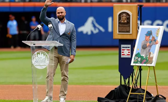 Carlos Beltran acknowledges fans during a ceremony to retire his number, Saturday, Sept. 19, 2026, in New York. (AP Photo/Noah K. Murray)