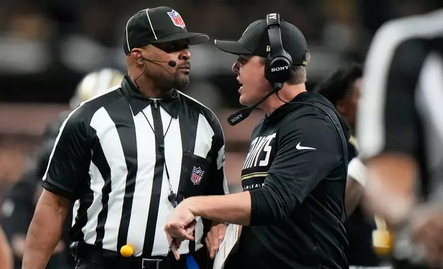 New Orleans Saints head coach Kellen Moore talks to an official after a penalty was issued to his team during the first half of an NFL football game against the Las Vegas Raiders in New Orleans, Sunday, Sept. 27, 2026. (AP Photo/Gerald Herbert)
