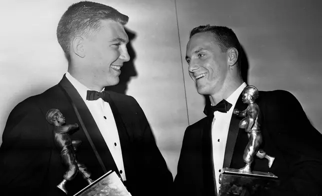 FILE - Jerry Stovall, right, of LSU, holds the Walter Camp Trophy and stands next to Pat Richter, of Wisconsin, holding the Knute Rockne Trophy after receiving them in Washington, Jan. 12, 1963. (AP Photo/BHR, File)