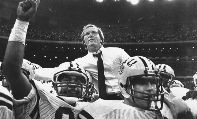 FILE - LSU football players hoist head coach Jerry Stovall to their shoulders after their victory over Tulane during a NCAA college football game in New Orleans, Nov. 25, 1983. (AP Photo/Bill Feig, File)