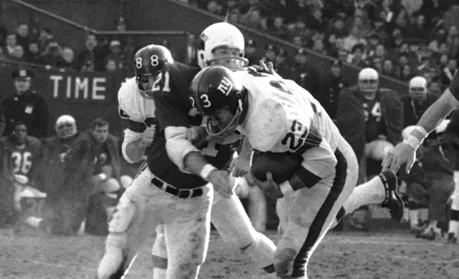 FILE - With a ball tucked under his arm, New York Giants Ernie Koy is brought down from behind by St. Louis Cardinals Jerry Stovall in the first period of an NFL football game at Yankee Stadium, Dec. 18, 1967, in New York. (AP Photo/Harry Harris)