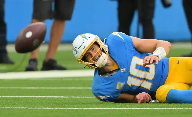 Los Angeles Chargers quarterback Justin Herbert (10) fumbles as he is tackled by Las Vegas Raiders defensive end Malcolm Koonce (51) during the second half of an NFL football game in Inglewood, Calif., Sunday, Sept. 20, 2026. (AP Photo/Jayne Kamin-Oncea)