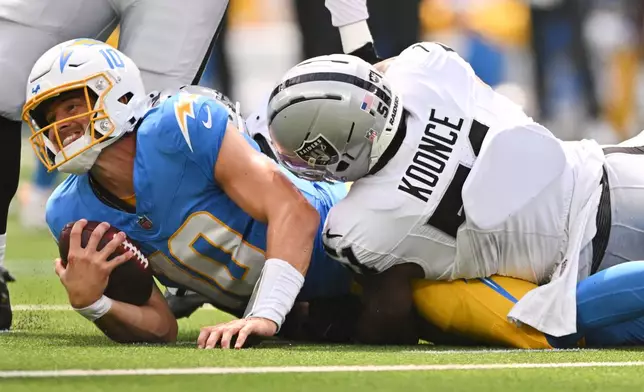 Los Angeles Chargers quarterback Justin Herbert (10) is sacked by Las Vegas Raiders defensive end Malcolm Koonce (51) during the first half of an NFL football game in Inglewood, Calif., Sunday, Sept. 20, 2026. (AP Photo/Katie Chin)
