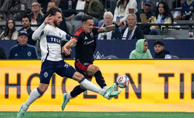 Vancouver Whitecaps' Tristan Blackmon, left, and D.C. United's Joao Peglow, right, vie for the ball during the first half of an MLS soccer match in Vancouver, British Columbia, Saturday, Sept. 26, 2026. (Jacob Mallari/The Canadian Press via AP)