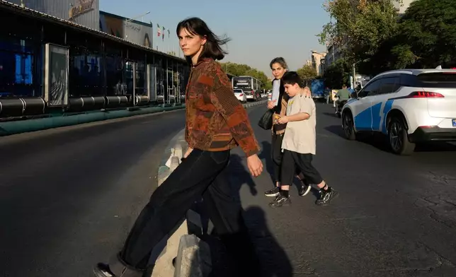 Pedestrians cross the Islamic Revolution street in downtown Tehran, Tuesday, Sept. 15, 2026. (AP Photo/Vahid Salemi)