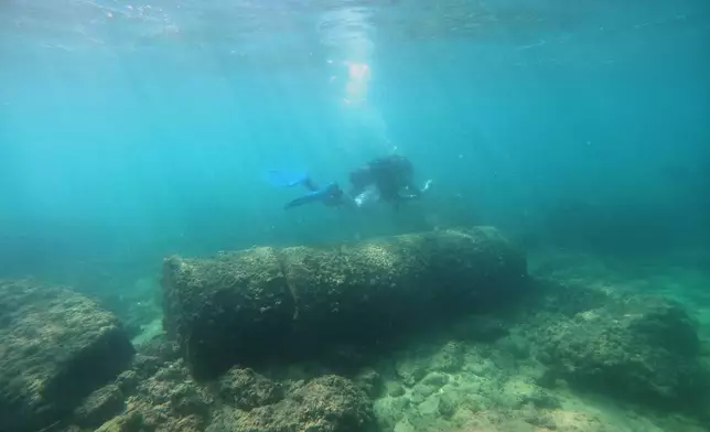 A diver passes above Roman-era columns at an archaeological site near the coast in the southern port city of Tyre, Lebanon, Thursday, Sept. 17, 2026. (AP Photo/Bilal Hussein)