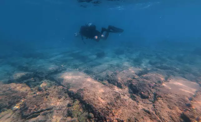Manager of the Lebanon Diving Center Youssef Jundi passes above an ancient passageway at an archaeological site near the coast in the southern port city of Tyre, Lebanon, Thursday, Sept. 17, 2026. (AP Photo/Bilal Hussein)