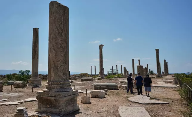 People visit Roman-era columns stand at an archaeological site in the southern port city of Tyre, Lebanon, Thursday, Sept. 17, 2026. (AP Photo/Bilal Hussein)