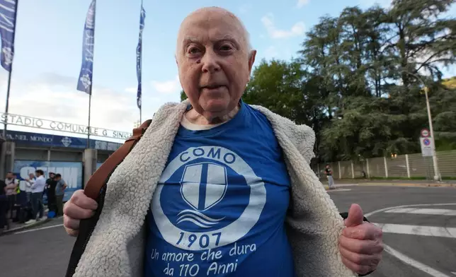 Como older fan Luigi Chiesa, 92, poses in front of the stadium ahed of the Champions League opening phase soccer match between Como and Leipzig in Como, Italy, Thursday, Sept. 10, 2026, Como officials giving up seats to older fans. (AP Photo/Luca Bruno)