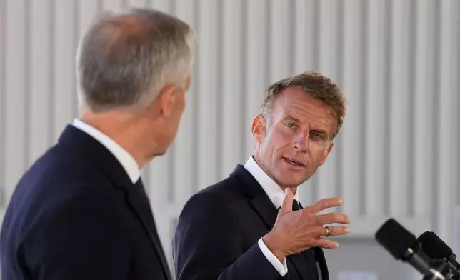 French President Emmanuel Macron, right, looks to Canadian Prime Minister Mark Carney as he delivers remarks in Saint-Pierre, Saint-Pierre-et-Miquelon, Sunday, Sept.20, 2026. (Adrian Wyld/The Canadian Press via AP)
