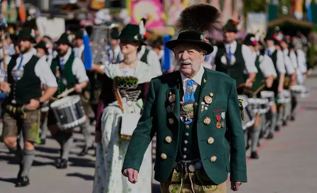 People wear traditional costumes in the Oktoberfest parade at the 191st Oktoberfest beer festival in Munich, Germany, Saturday, Sept.19, 2026. (AP Photo/Matthias Schrader)