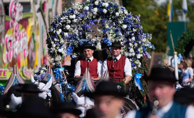 People wear traditional costumes in the Oktoberfest parade at the 191st Oktoberfest beer festival in Munich, Germany, Saturday, Sept.19, 2026. (AP Photo/Matthias Schrader)