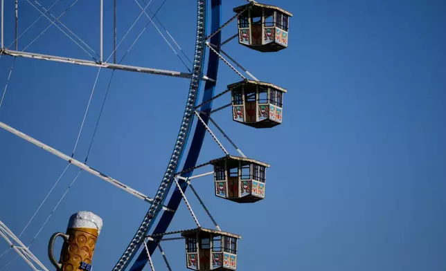 A ferris wheel is seen at the 191st Oktoberfest beer festival in Munich, Germany, Saturday, Sept.19, 2026. (AP Photo/Matthias Schrader)