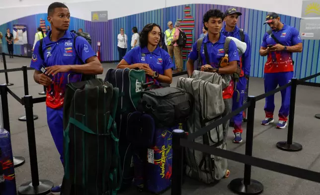 Passengers wait to check in at Simon Bolivar International Airport as it reopens to commercial flights two months after closing due to the earthquake in Maiquetia, Venezuela, Tuesday, Sept. 1, 2026. (AP Photo/Pedro Mattey)