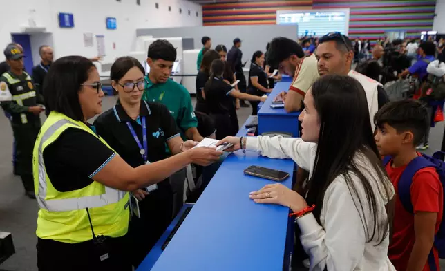 Passengers check in at Simon Bolivar International Airport as it reopens to commercial flights two months after closing due to the earthquake in Maiquetia, Venezuela, Tuesday, Sept. 1, 2026. (AP Photo/Pedro Mattey)