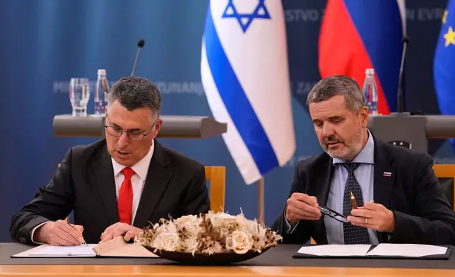 Israel's Foreign Minister Gideon Sa'ar, left, and his Slovenian counterpart Tone Kajzer sign bilateral agreements in Ljubljana, Slovenia, Wednesday, Sept. 9, 2026. (AP Photo/Darko Bandic)