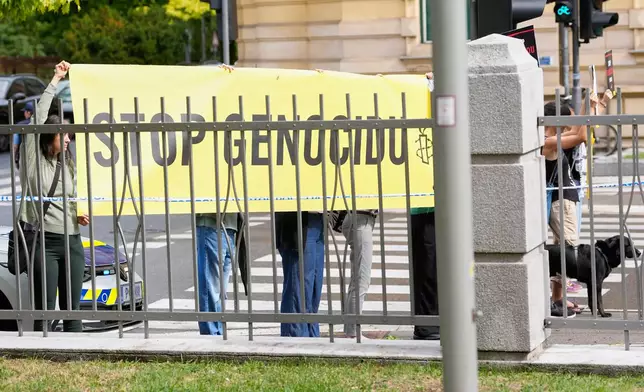 A group of protesters hold a banner outside the Slovenian foreign ministry during a visit of Israel's Foreign Minister Gideon Sa'ar, in Ljubljana, Slovenia, Wednesday, Sept. 9, 2026. (AP Photo/Darko Bandic)