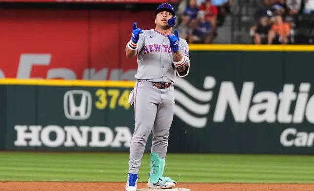 New York Mets' Francisco Alvarez celebrates his two-run double in the sixth inning of a baseball game against the Texas Rangers Tuesday, Sept. 22, 2026, in Arlington, Texas. (AP Photo/Tony Gutierrez)