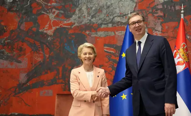 FILE - European Commission President Ursula von der Leyen, center, shakes hands with Serbian President Aleksandar Vucic in Belgrade, Serbia, on Oct. 25, 2024. (AP Photo/Darko Vojinovic, File)