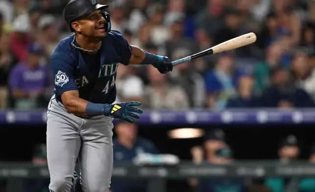 Seattle Mariners center fielder Julio Rodríguez watches his single in the third inning against the Colorado Rockies during a baseball game Saturday, Sept. 19, 2026, in Denver. (AP Photo/RJ Sangosti)