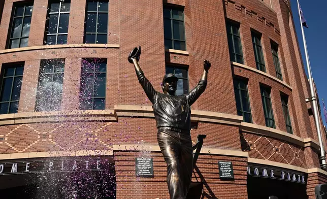 The Colorado Rockies unveil a bronze statue of franchise icon and Hall of Famer Todd Helton outside Coors Field in Denver, Saturday, Sept. 19, 2026. (AP Photo/RJ Sangosti)