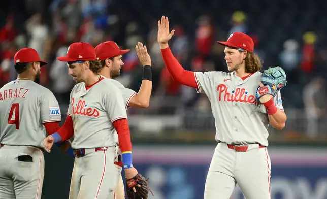 Philadelphia Phillies' Alec Bohm, right, and teammates celebrate after a baseball game against the Washington Nationals, Wednesday, Sept. 16, 2026, in Washington. (AP Photo/Nick Wass)