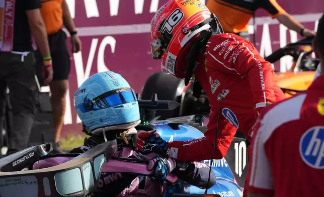 Ferrari driver Charles Leclerc of Monaco, right, congratulates Alpine driver Pierre Gasly of France, left, for his pole position after the qualifying session ahead of the Italian Formula One Grand Prix, in Monza, Italy, Saturday, Sept. 5, 2026. (AP Photo/Antonio Calanni)