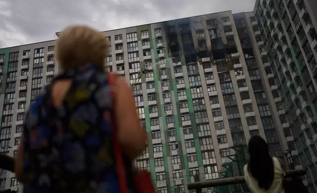 Firefighters work after a Russian drone attack struck a residential building in Kyiv, Tuesday, Sept. 1, 2026. (AP Photo/Francisco Seco)