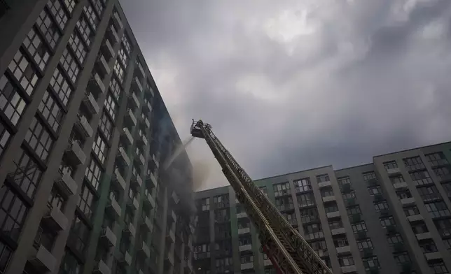 Firefighters work after a Russian drone attack struck a residential building in Kyiv, Tuesday, Sept. 1, 2026. (AP Photo/Francisco Seco)