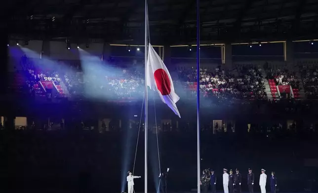 Japanese flag is unfurled during the opening ceremony for the Asian Games in Nagoya, Japan, Saturday, Sept. 19, 2026. (AP Photo/Aaron Favila)
