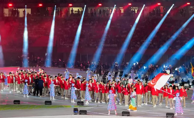 Singapore athletes march into the stadium during the opening ceremony for the Asian Games in Nagoya, Japan, Saturday, Sept. 19, 2026. (AP Photo/Eugene Hoshiko)