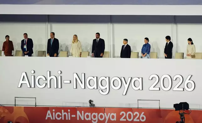 Japan's Emperor Naruhito, fourth right, Empress Masako, third right, Crown Prince Akishino, second right, and Crown Princess Kiko, right, stand with officials as they attend the opening ceremony for the Asian Games in Nagoya, Japan, Saturday, Sept. 19, 2026. (AP Photo/Dita Alangkara)