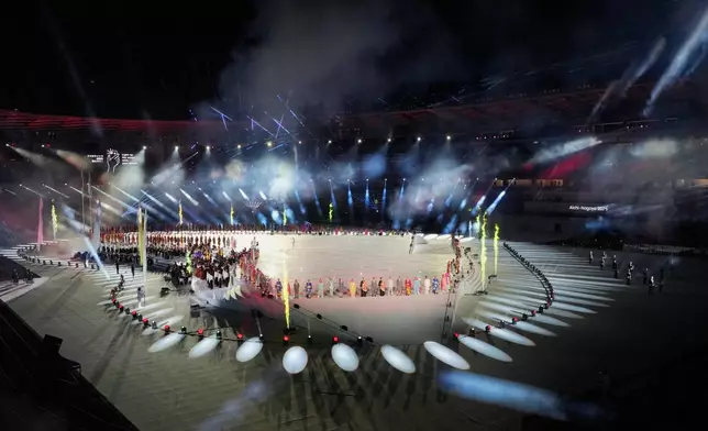 Performers gather in the stadium during the opening ceremony for the Asian Games in Nagoya, Japan, Saturday, Sept. 19, 2026. (AP Photo/Dita Alangkara)