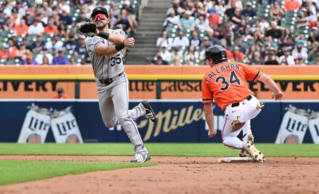 Colorado Rockies second baseman Connor Norby, left, throws to first base to complete the double play as Detroit Tigers' Brett Callahan is out at second base during the second inning of a baseball game, Saturday, Sept. 12, 2026, in Detroit. (AP Photo/Jose Juarez)