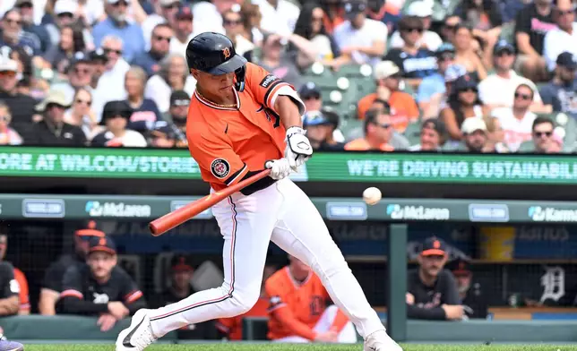 Detroit Tigers' Hao-Yu Lee hits an RBI double during the fourth inning of a baseball game against the Colorado Rockies, Saturday, Sept. 12, 2026, in Detroit. (AP Photo/Jose Juarez)
