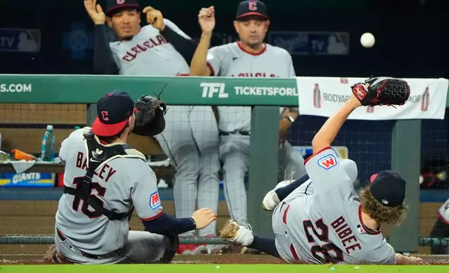 Cleveland Guardians catcher Patrick Bailey (16) and starting pitcher Tanner Bibee (28) miss catching a foul ball hit by Kansas City Royals' Carter Jensen during the fifth inning of a baseball game, Saturday, Sept. 26, 2026, in Kansas City, Mo. (AP Photo/Charlie Riedel)