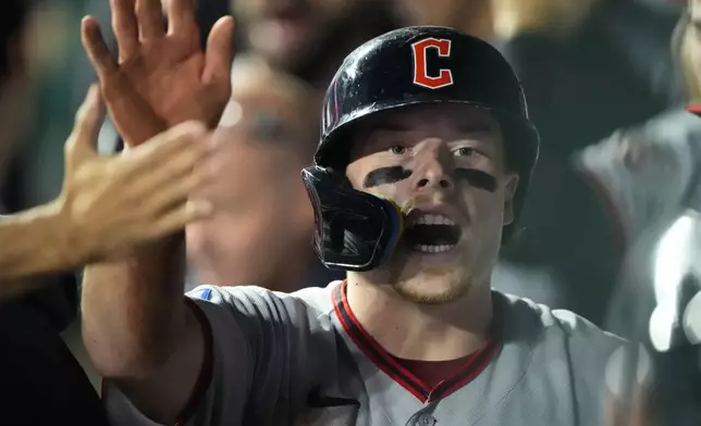 Cleveland Guardians' Travis Bazzana celebrates in the dugout after scoring on a sacrifice fly hit by Nathaniel Lowe during the sixth inning of a baseball game against the Kansas City Royals, Saturday, Sept. 26, 2026, in Kansas City, Mo. (AP Photo/Charlie Riedel)