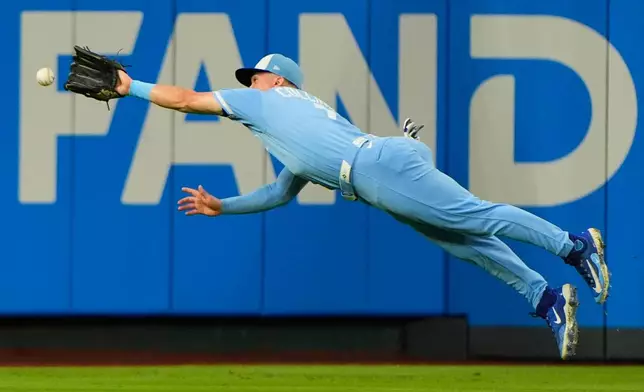 Kansas City Royals left fielder Isaac Collins can't make the catch of a triple hit by Cleveland Guardians' Steven Kwan during the second inning of a baseball game, Saturday, Sept. 26, 2026, in Kansas City, Mo. (AP Photo/Charlie Riedel)