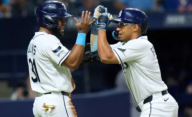 Tampa Bay Rays' Richie Palacios, right, celebrates his two-run home run off New York Mets pitcher Chris Devenski with Cedric Mullins during the fourth inning of a baseball game Wednesday, Sept. 2, 2026, in St. Petersburg, Fla. (AP Photo/Chris O'Meara)